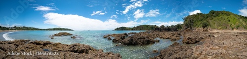 Panorama of stone seashore and blue sea New Zealand