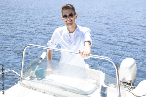 young man on the yacht's summer vacation © carballo