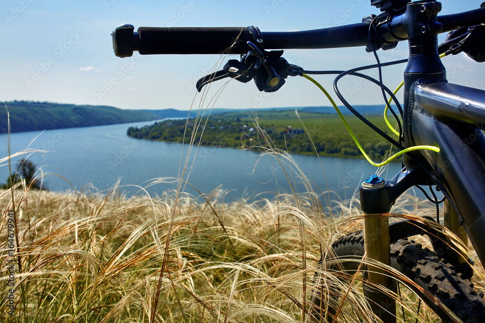 Close-up of detail of the mountain bicycle on the green grass. Close-up of detail of the mountain bicycle on the green grass.