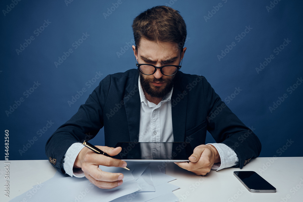 Business man with a beard working at his desk in the office Business man with a beard working at his desk in the office