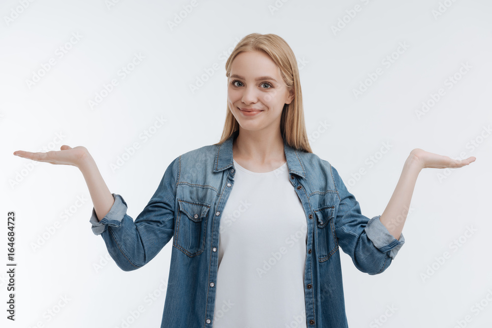 Joyful young woman holding arms bent in elbows Joyful young woman holding arms bent in elbows
