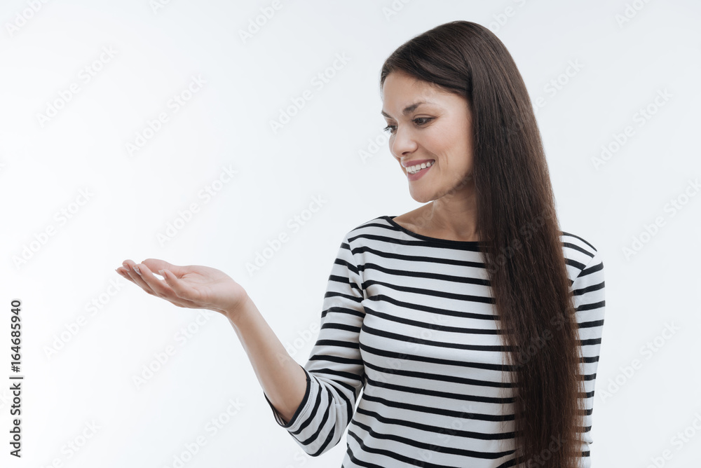 Cheerful longhaired woman looking at her hand Cheerful longhaired woman looking at her hand