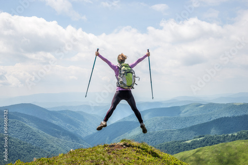 Young woman jumping in the mountains