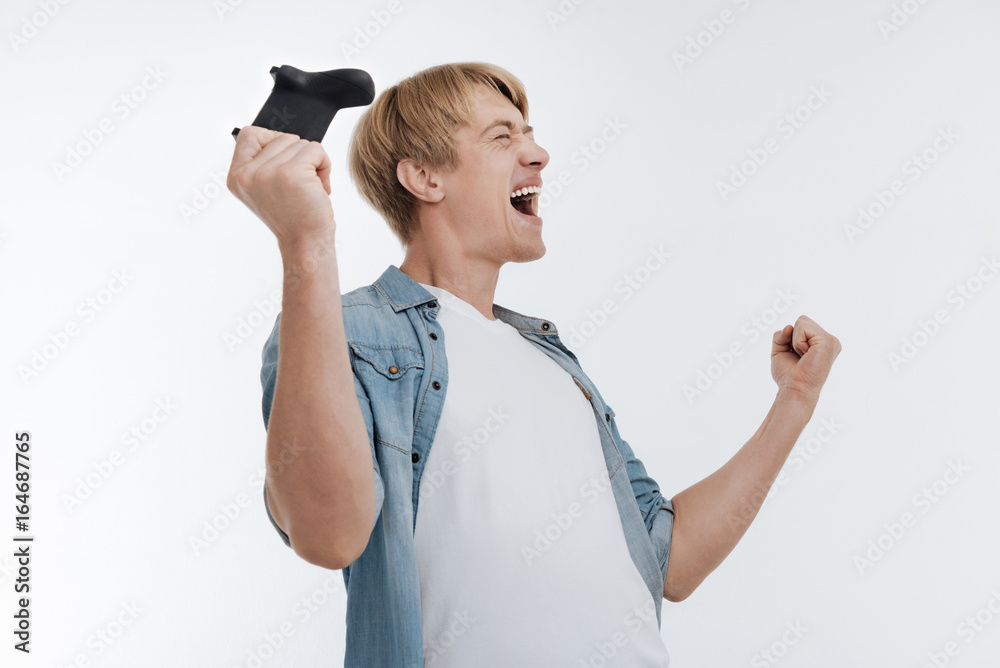 Satisfied man celebrating his win in game Satisfied man celebrating his win in game