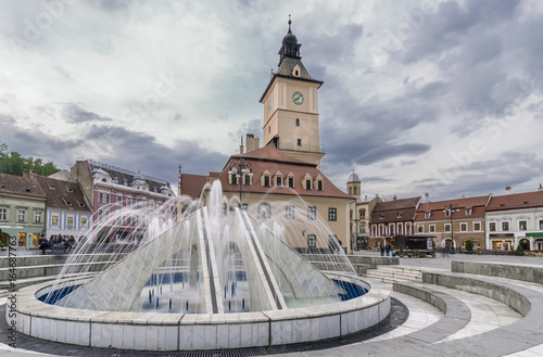 View of the Fantana arteziana din Piata Sfatului fountain, Council square, historic center of Brasov, Romania photo