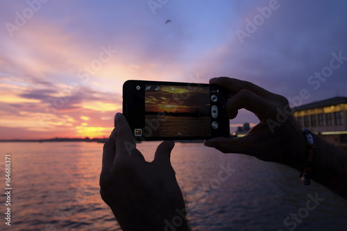 Tourist is Taking Sunset Photo with Smart Phone at The Istanbul
 photo