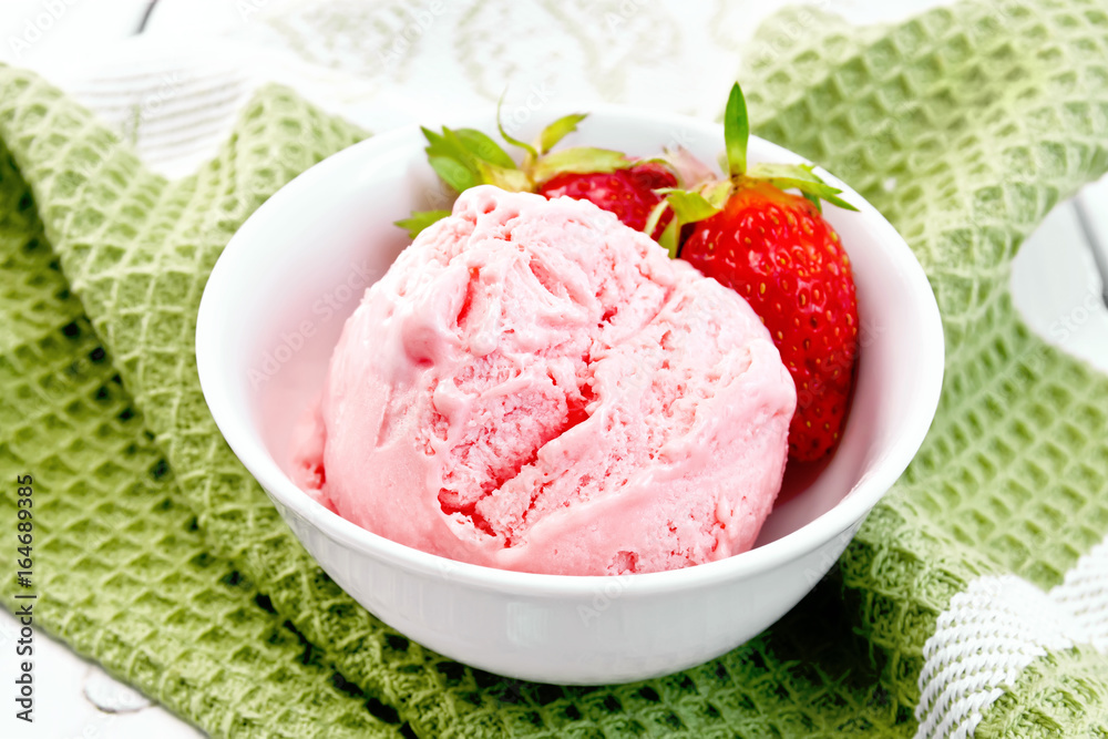 Ice cream strawberry with berries in bowl on green napkin Ice cream strawberry with berries in bowl on green napkin
