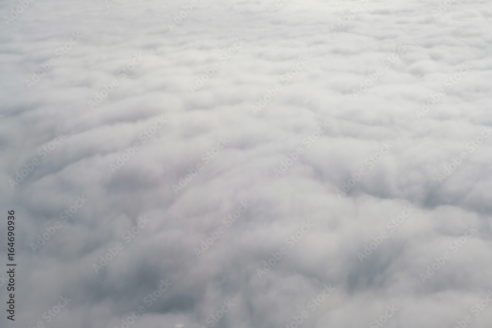 Aerial view from the plane of fluffy rain cloud in daytime - Cloudscape