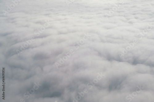 Aerial view from the plane of fluffy rain cloud in daytime - Cloudscape