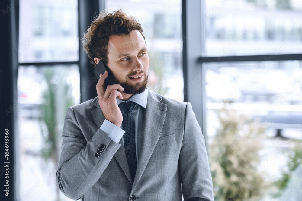 portrait of businessman in suit talking on smartphone in office portrait of businessman in suit talking on smartphone in office