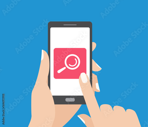 Hand holding smartphone and touching the screen with search button. Magnifying glass icon.