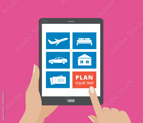 Hands holding tablet computer and touching screen with icons of hotel, flight, car, tickets and plan a trip button.