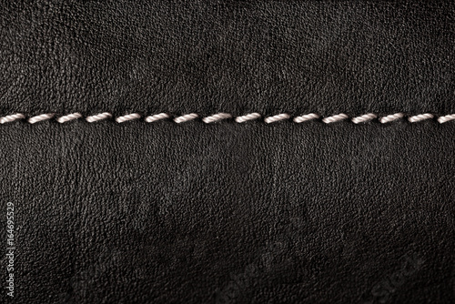 Black leather texture background with white seams
