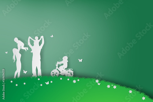 Green background happy family having fun playing in the field,vector,paper art style