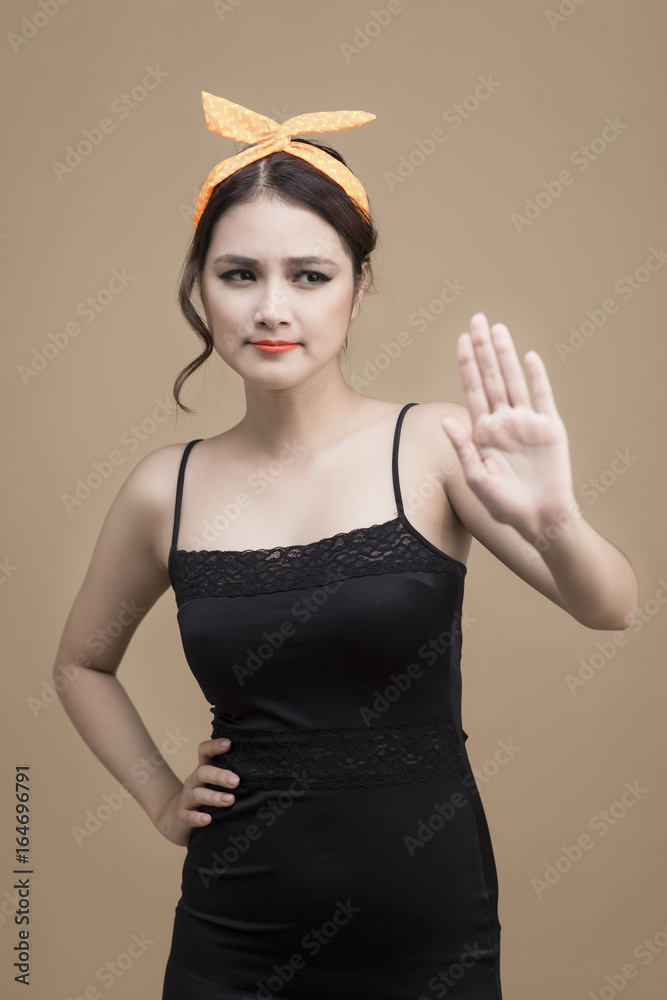 Portrait of asian girl with pretty smile in pinup style with hands gesture on yellow background