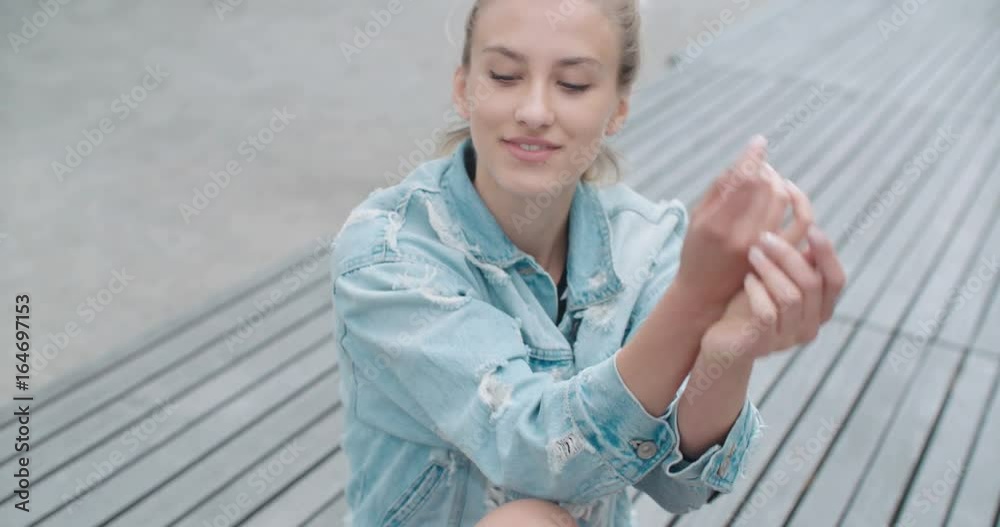Pretty fashion woman in a city in Europe. Happy stylish girl wearing denim jacket enjoying her time during sunny day. Pretty fashion woman in a city in Europe. Happy stylish girl wearing denim jacket enjoying her time during sunny day.