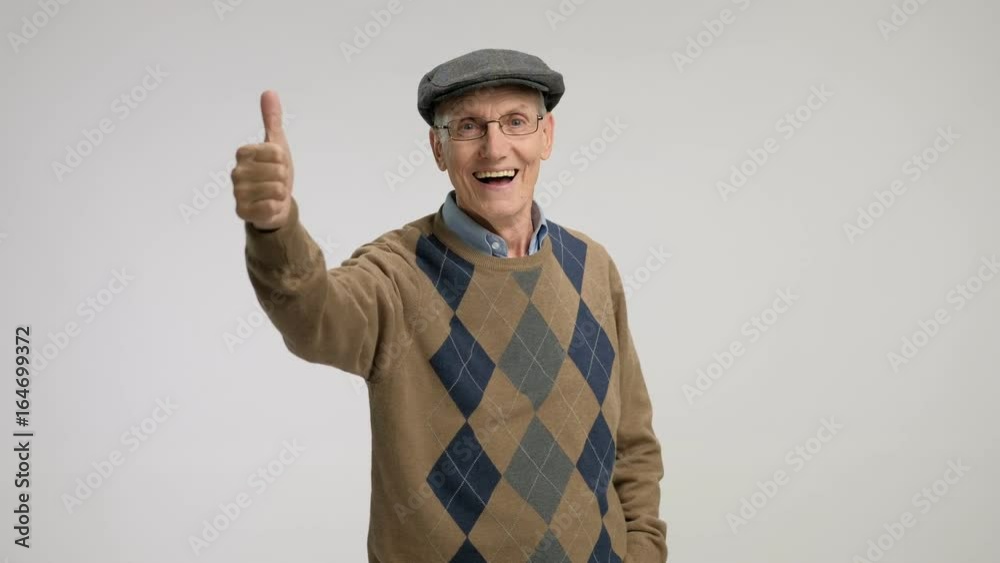 Senior making a thumb up gesture and smiling Senior making a thumb up gesture and smiling