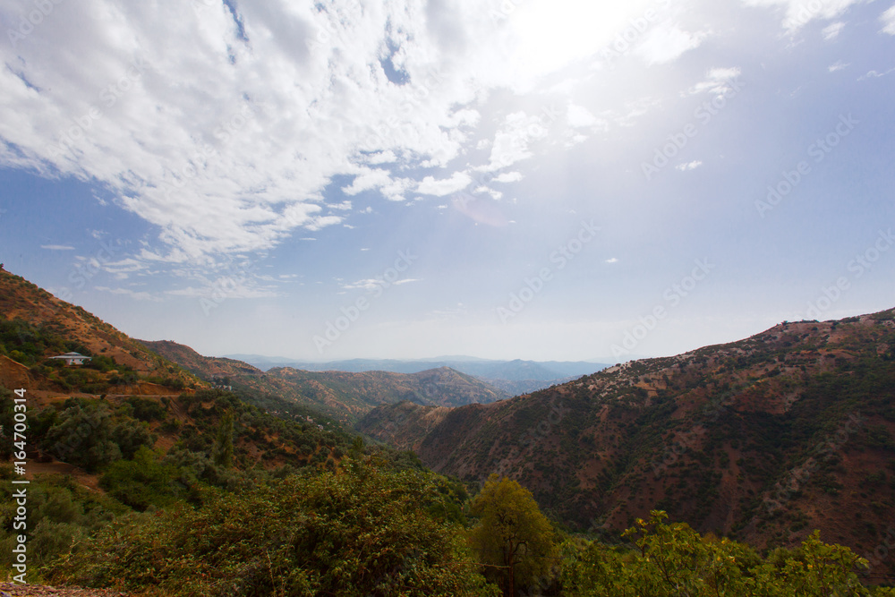Naklejka premium mountains landscape.sky.taberrant. Moroccan rural life.