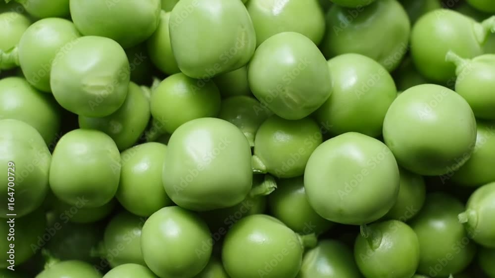 Fresh green peas rotate. Top view. Close up