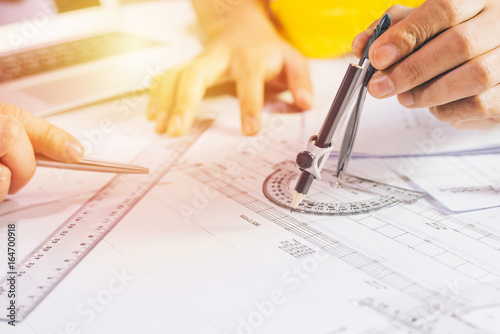 Hands of Engineer working Design on blueprint,Construction concept. Engineering tools,Architectural project,blueprint rolls and divider compass. Construction concept,Copy space,business industrial