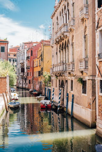 View on a venetian canal with ancient buildings and bridge in Venice