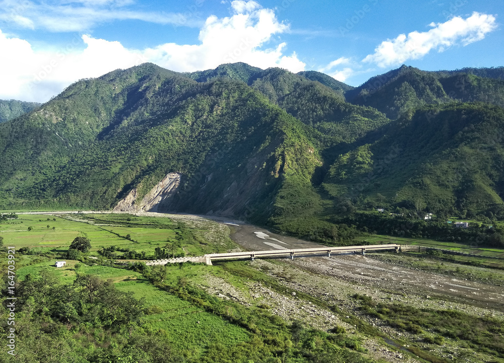 Naklejka premium Beautiful Mountain and Bridge over the flowing river
