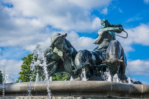 View of famous Gefion Fountain (Gefionspringvandet 1899) in Copenhagen. Gefion Fountain depicting legendary Norse goddess driving four oxen. It was designed by Danish artist Anders Bundgaard. Denmark.