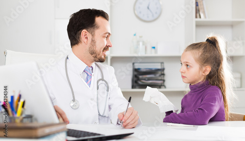 Male doctor and little girl
