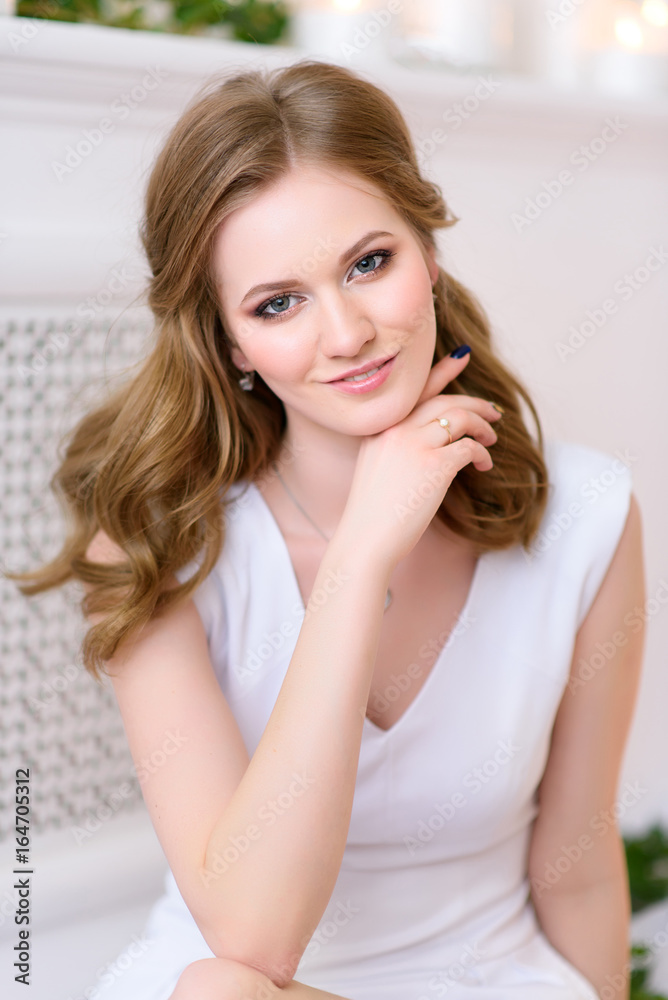 Portrait picture of a beautiful young girl in an elegant white dress with a nice straight glance. Beautiful young woman with shiny hair and bright makeup. Lifestyle and cosmetics concept. Studio shot Portrait picture of a beautiful young girl in an elegant white dress with a nice straight glance. Beautiful young woman with shiny hair and bright makeup. Lifestyle and cosmetics concept. Studio shot