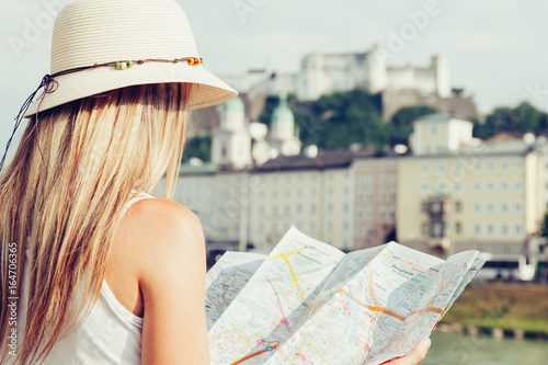 Female tourist on vacation in Salzburg Austria holding a local map photo