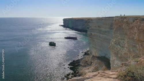 Wallpaper Mural Rocky cliffs of sea coast / Landscape of sea bay with rocky coast in sunny day Torontodigital.ca