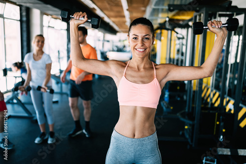 Young attractive woman doing exercises in gym