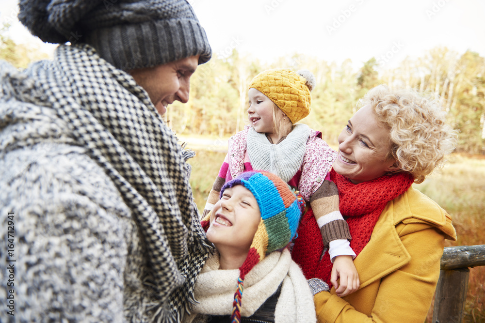 Obraz premium Family having a walk in autumnal forest