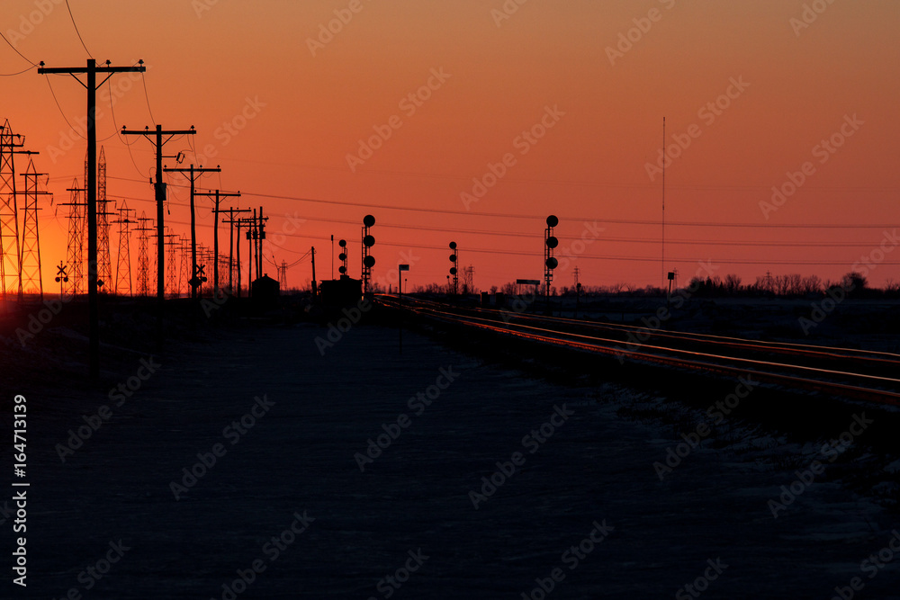 Telephone Poles and Railway Tracks at Sunset