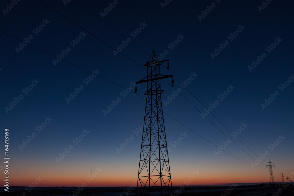 Tall Transmission Tower Against Beautiful Blue Sunset
