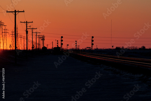 Telephone Poles and Railway Tracks at Sunset