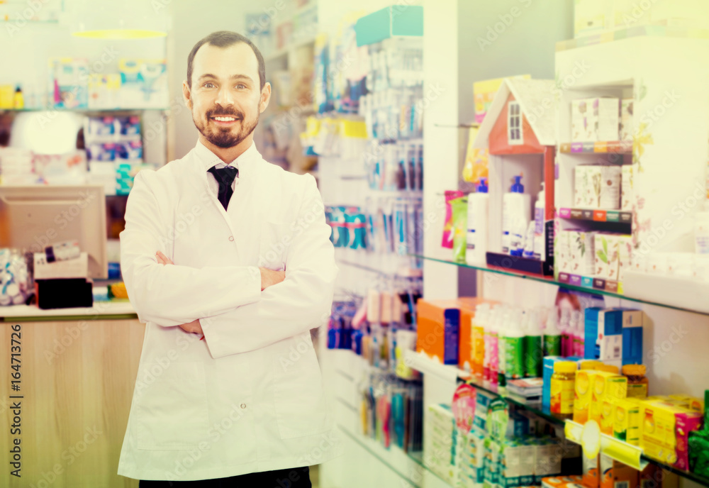 Male pharmacist demonstrating assortment of drugs