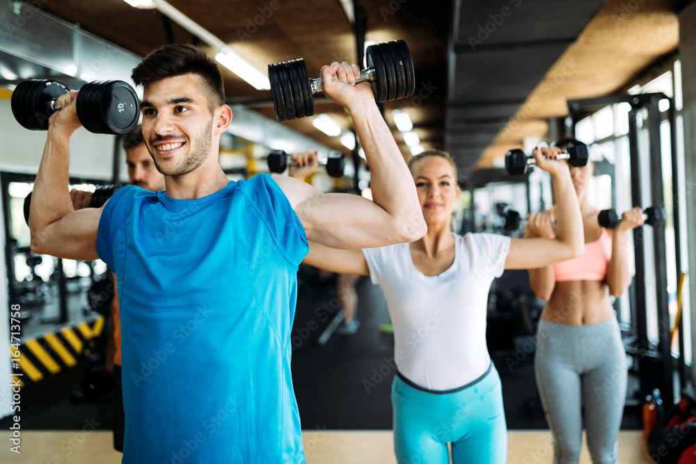 Group of friends exercising together in gym Group of friends exercising together in gym