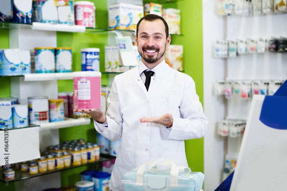 Positive male pharmacist offering assortment