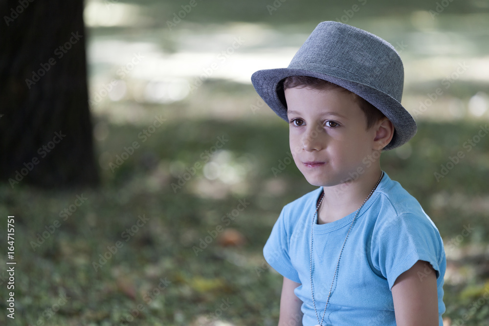 Portrait of little preschool kid boy with hat in summer Portrait of little preschool kid boy with hat in summer