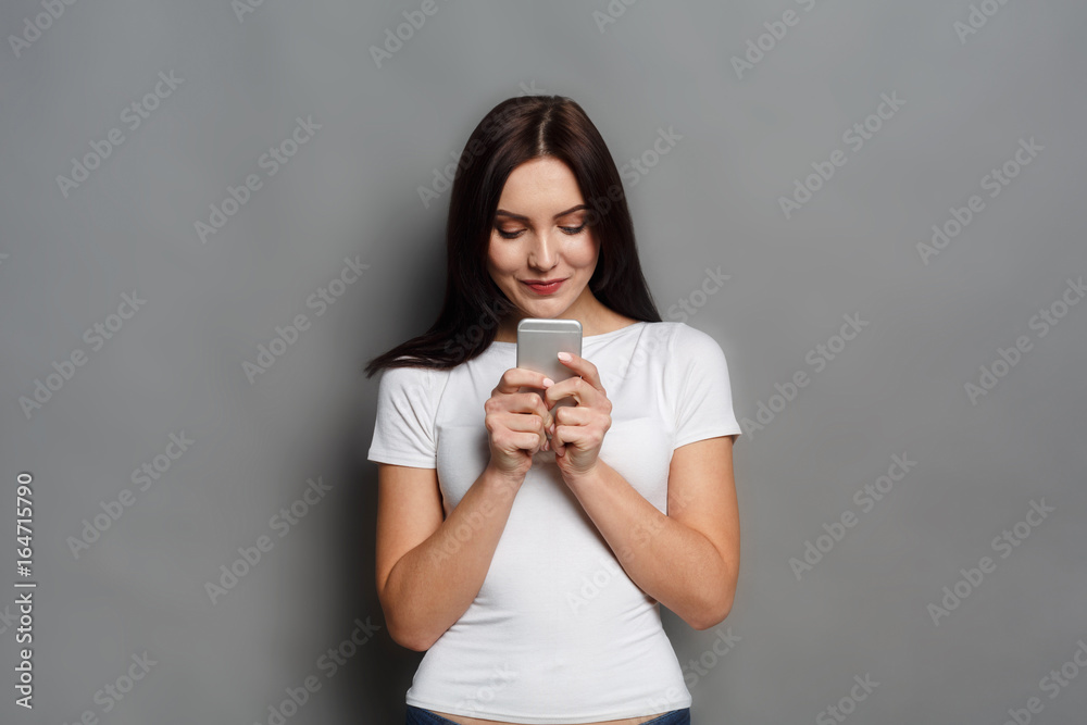 Young woman typing message on smartphone