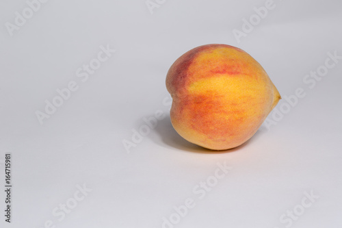 single ripe peach isolated on white background