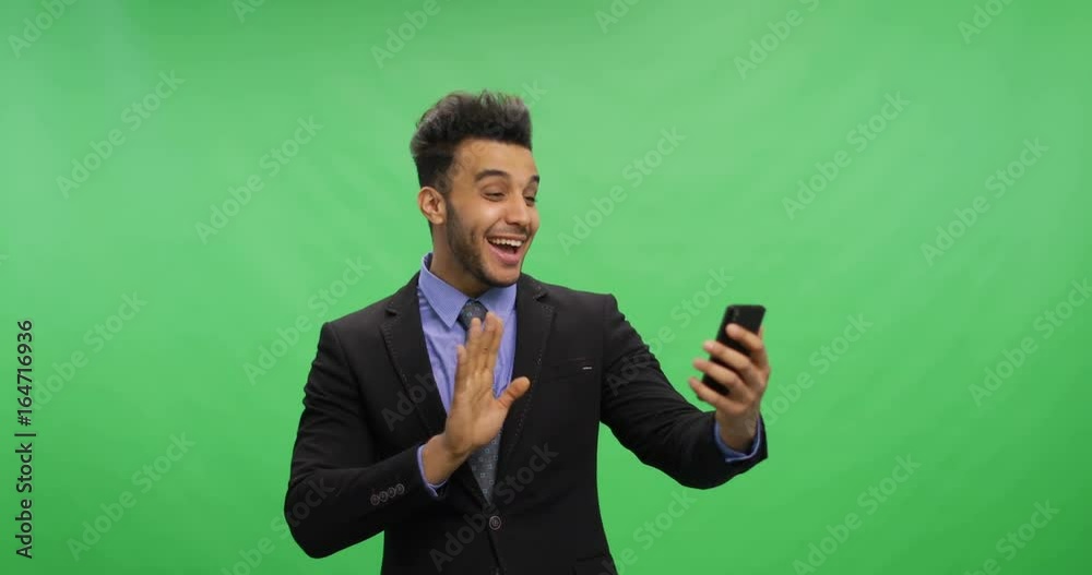 Cheerful Businessman Talking Online Use Cell Smart Phone Making Video Call Over Chroma Key Green Screen Happy Smiling Young Latin Business Man Portrait Cheerful Businessman Talking Online Use Cell Smart Phone Making Video Call Over Chroma Key Green Screen Happy Smiling Young Latin Business Man Portrait