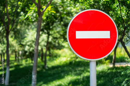 Red Stop Street Sign with City at the Background