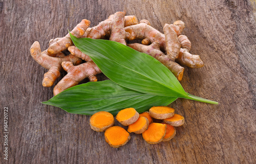 Fresh turmeric roots on wooden table