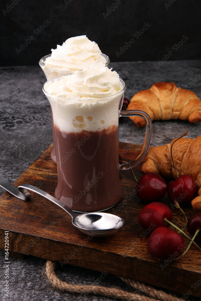Iced coffee with whipped cream in tall glass and fresh croissant Iced coffee with whipped cream in tall glass and fresh croissant
