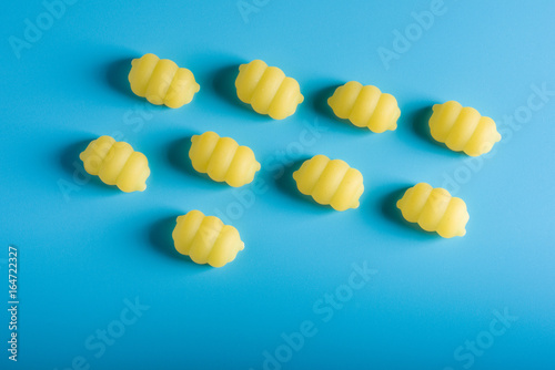 Gnocchi pasta pattern on a blue background