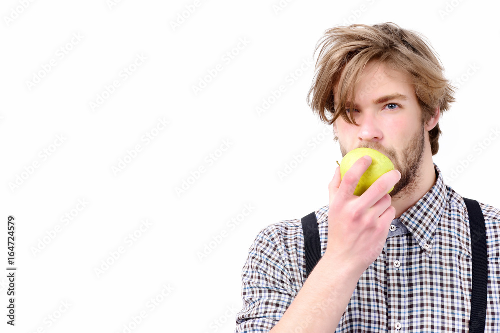 Man with beard and stylish hairdo holds green apple Man with beard and stylish hairdo holds green apple
