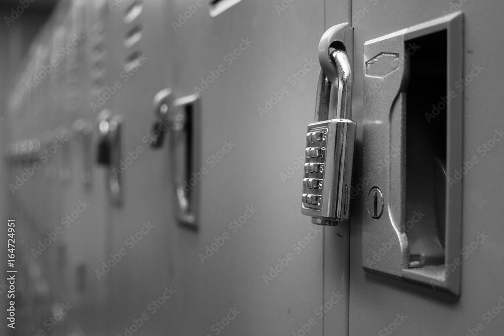Closeup padlock with key number hanging on locker for concept technology data log security on black and white Closeup padlock with key number hanging on locker for concept technology data log security on black and white
