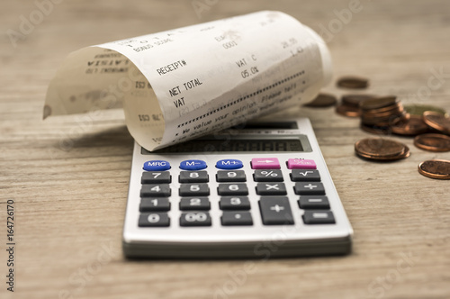 Close up shot of calculator and shopping receipt